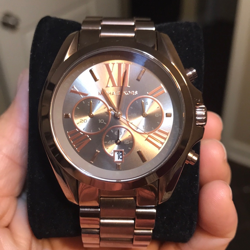 Woman’s Michale Kors watch metallic brown